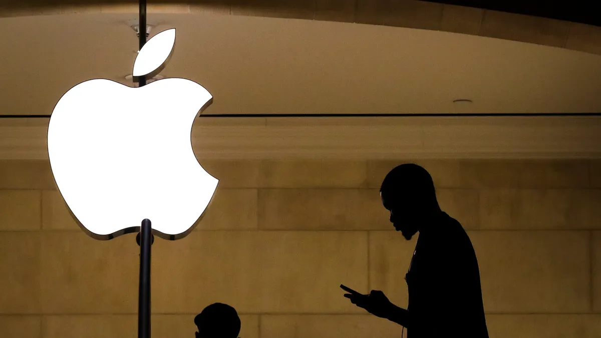 A man checks his phone in an Apple retail store in Grand Central Terminal in New York City.