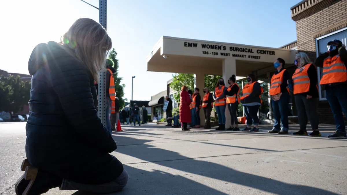 A pro-life demonstrator prostrates before a line of volunteer clinic escorts in front of the EMW Women's Surgical Center, an abortion clinic, on May 8, 2021 in Louisville, Kentucky.