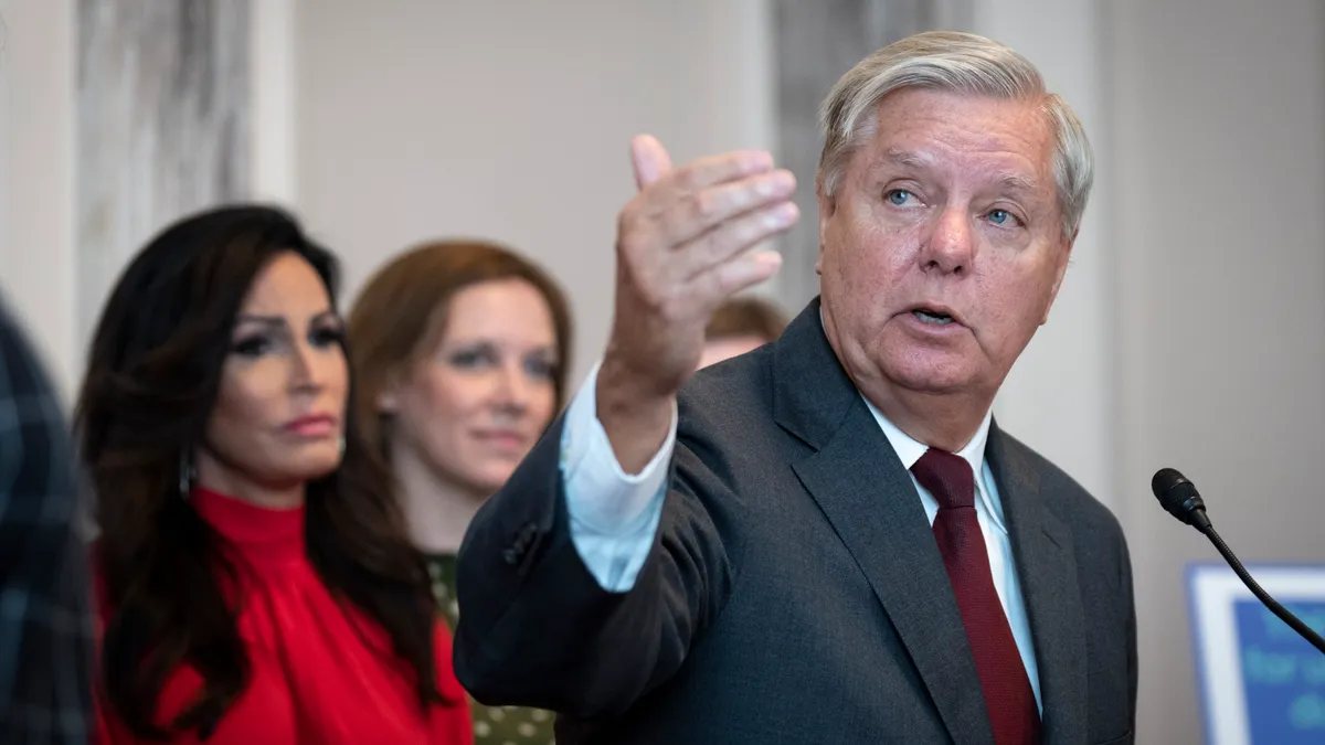 Lindsey Graham gestures with his hand at a podium.