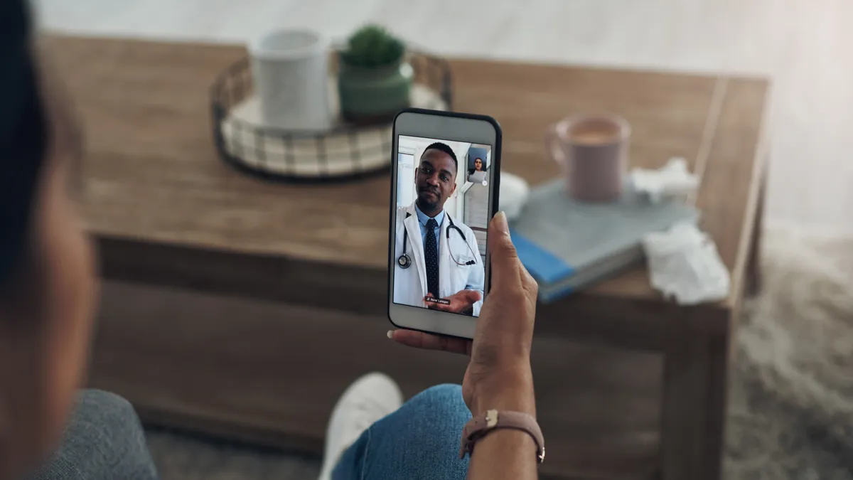 Shot of an unrecognizable person on a videocall with a doctor - stock photo