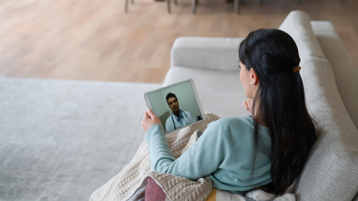 Latino woman getting help from doctor via tablet