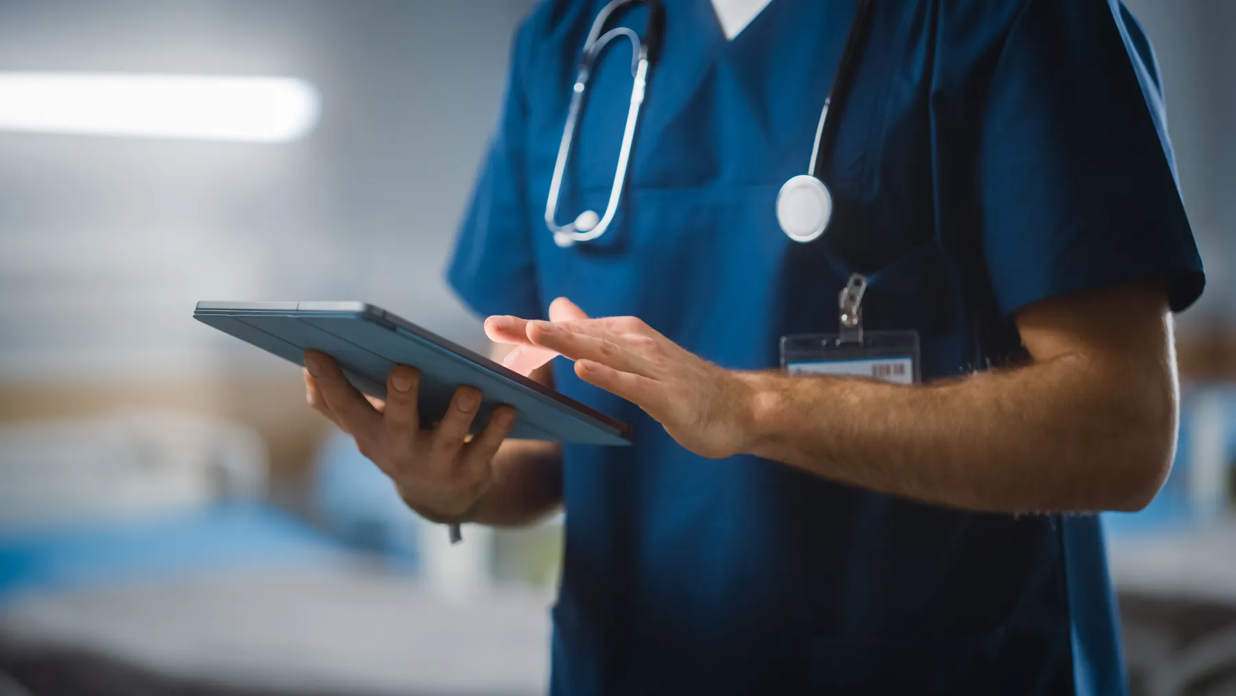 Healthcare worker works on a digital tablet