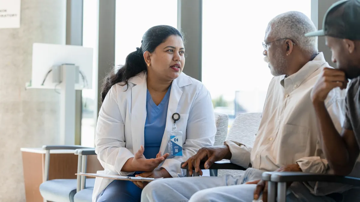 A doctor talking to a patient and a family member.