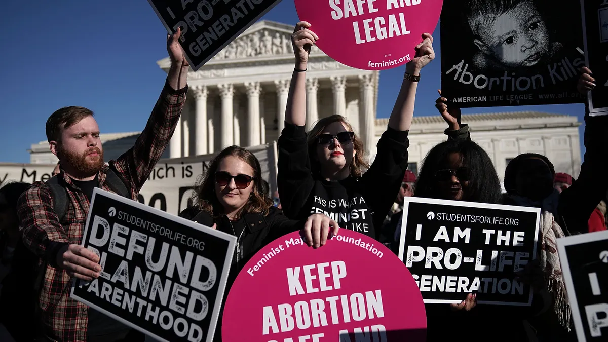 Antiabortion and abortion-rights protestors gather outside the Supreme Court.